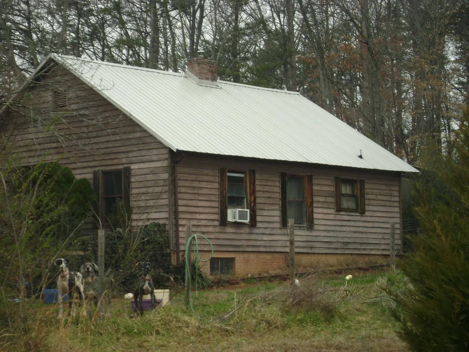 White metal roof on an old wood sided farmhouse, from a Metal Roof Installation job in Bladenboro